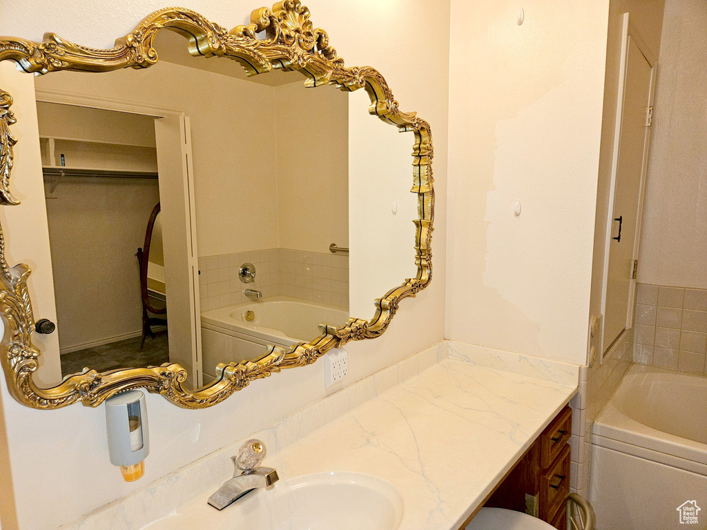 Bathroom featuring a bathtub and oversized vanity