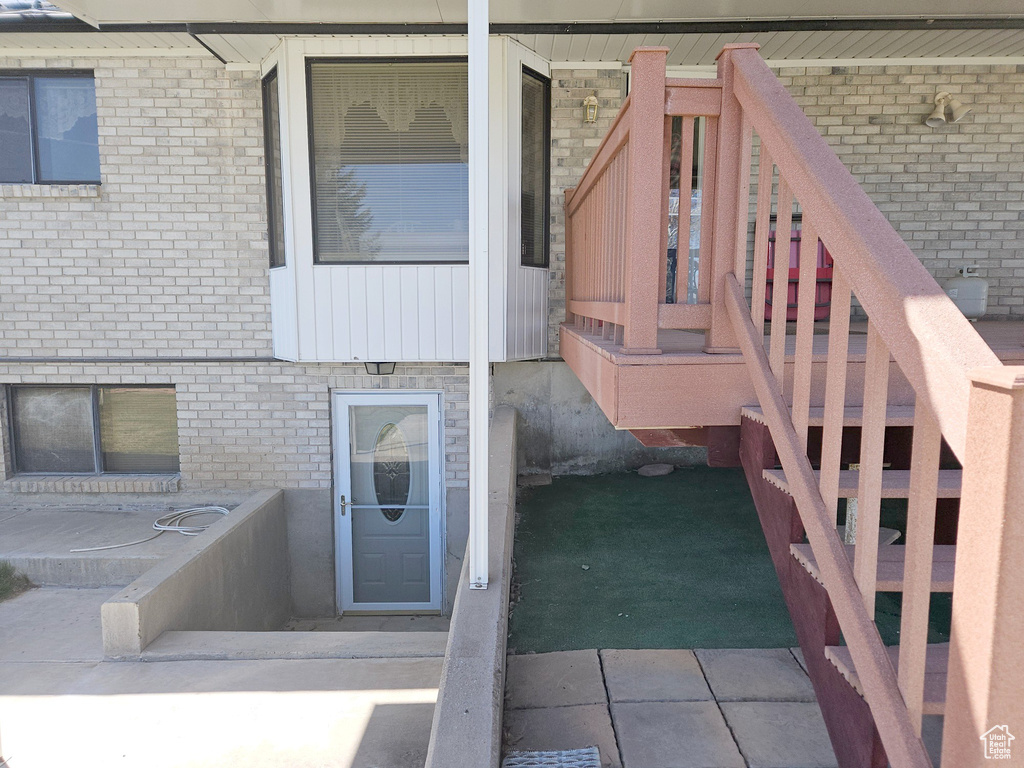 Exterior space with tile flooring and brick wall