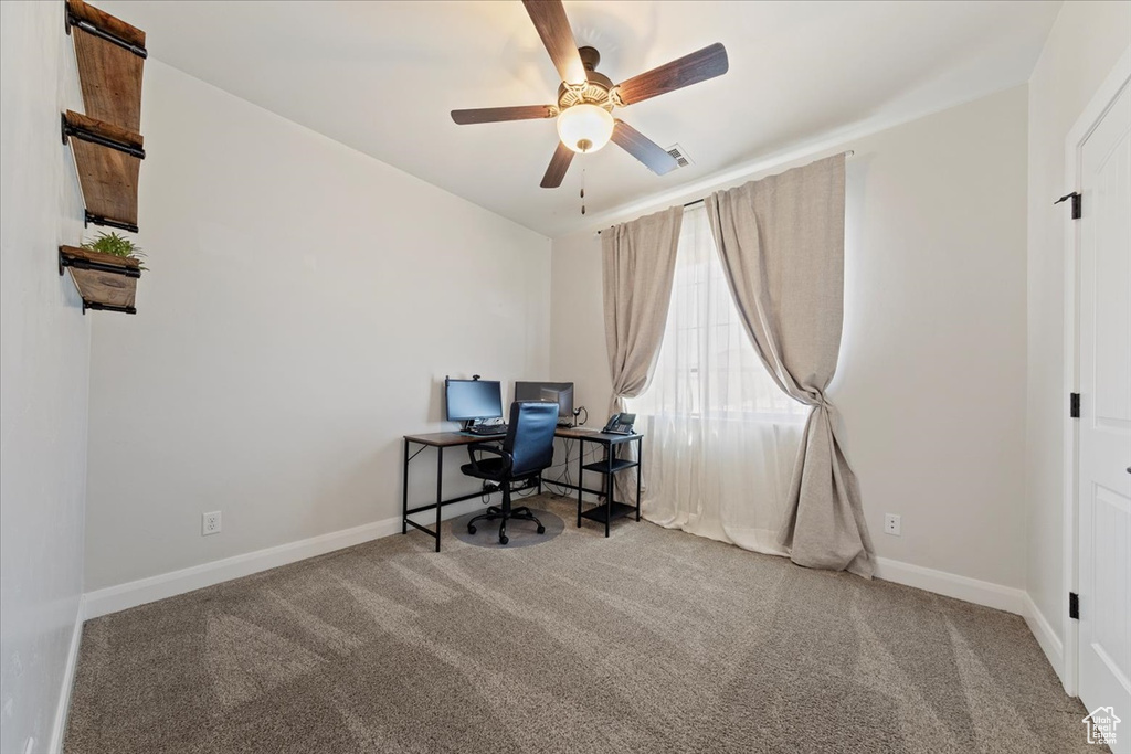 Unfurnished office with ceiling fan and carpet flooring