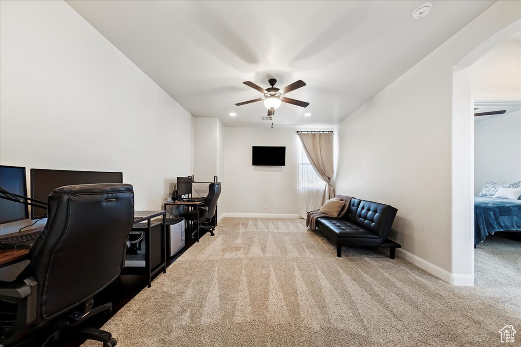 Office with light colored carpet and ceiling fan