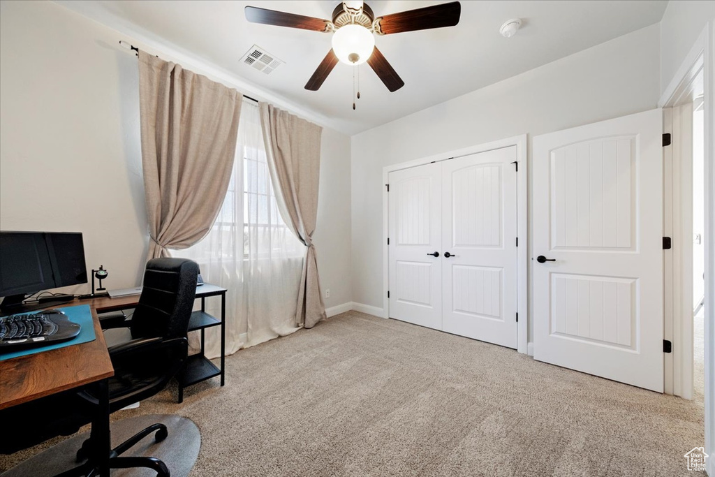 Office area featuring ceiling fan and light carpet