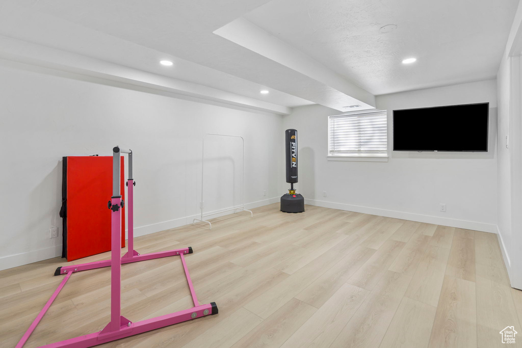 Exercise area featuring light hardwood / wood-style floors