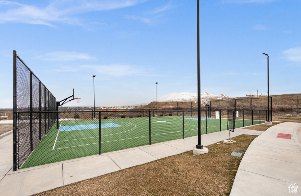 View of tennis court featuring a mountain view and basketball court