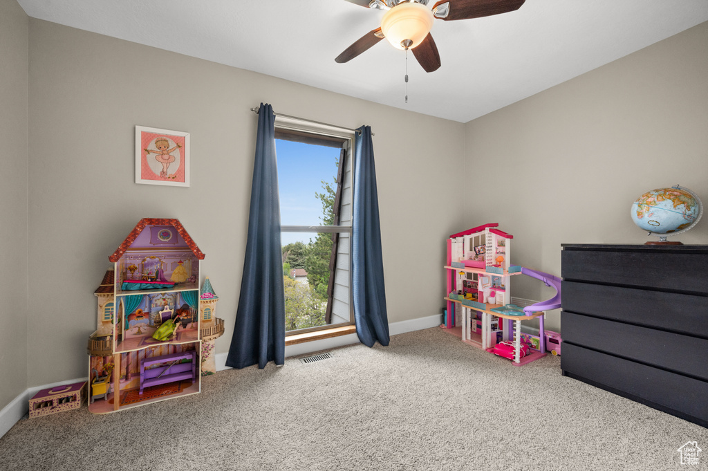 Playroom featuring ceiling fan and carpet floors
