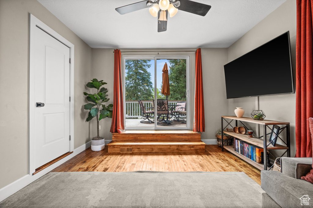 Sitting room featuring hardwood / wood-style flooring and ceiling fan