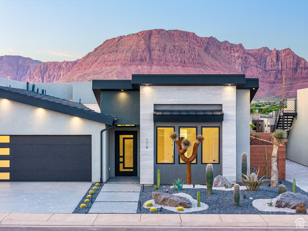 Contemporary home featuring a mountain view and a garage