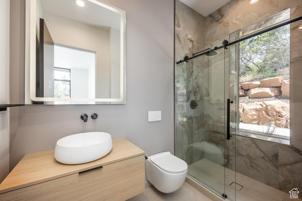 Bathroom with vanity, toilet, and walk in shower