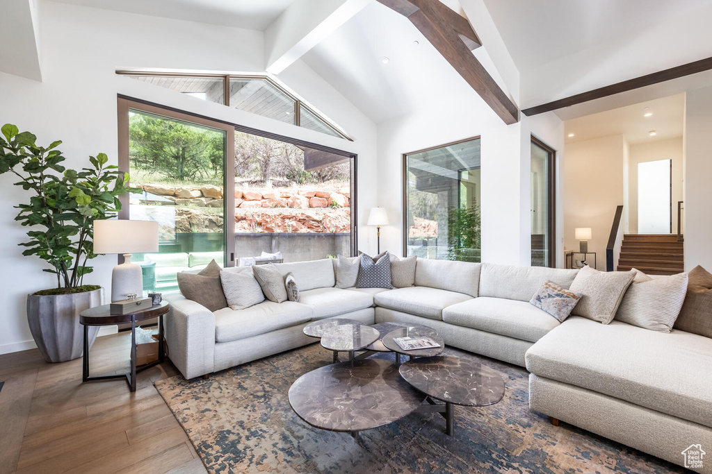 Living room featuring hardwood / wood-style floors and vaulted ceiling with beams