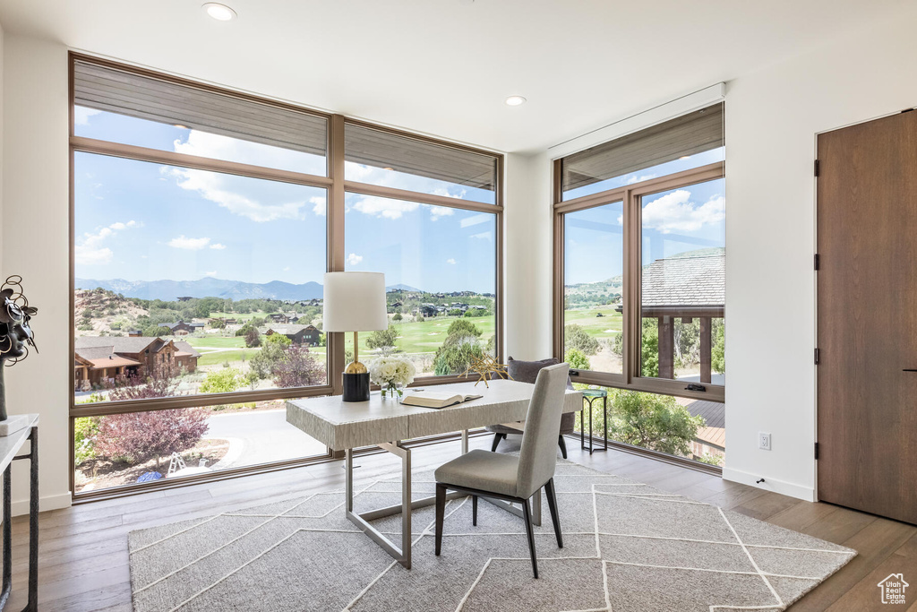 Dining area featuring expansive windows, hardwood / wood-style flooring, and a mountain view