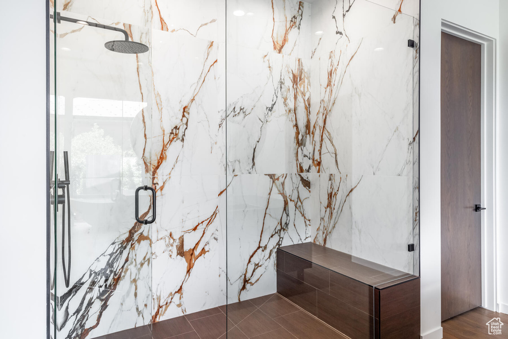 Bathroom featuring an enclosed shower and hardwood / wood-style flooring