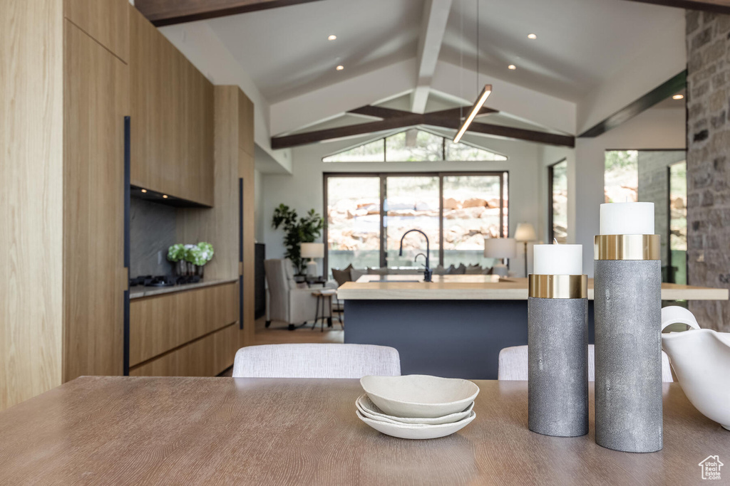 Kitchen with vaulted ceiling with beams