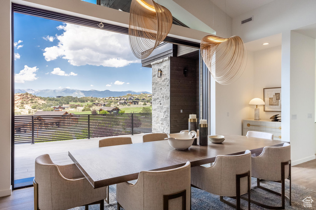 Dining area with a mountain view and wood-type flooring