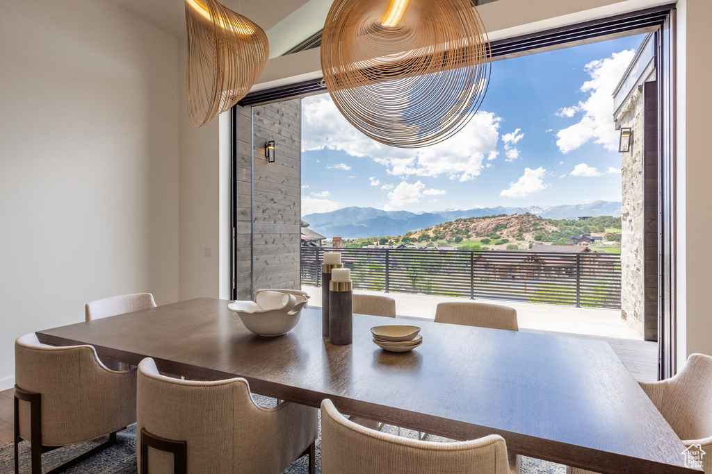 Dining area featuring wood-type flooring and a mountain view