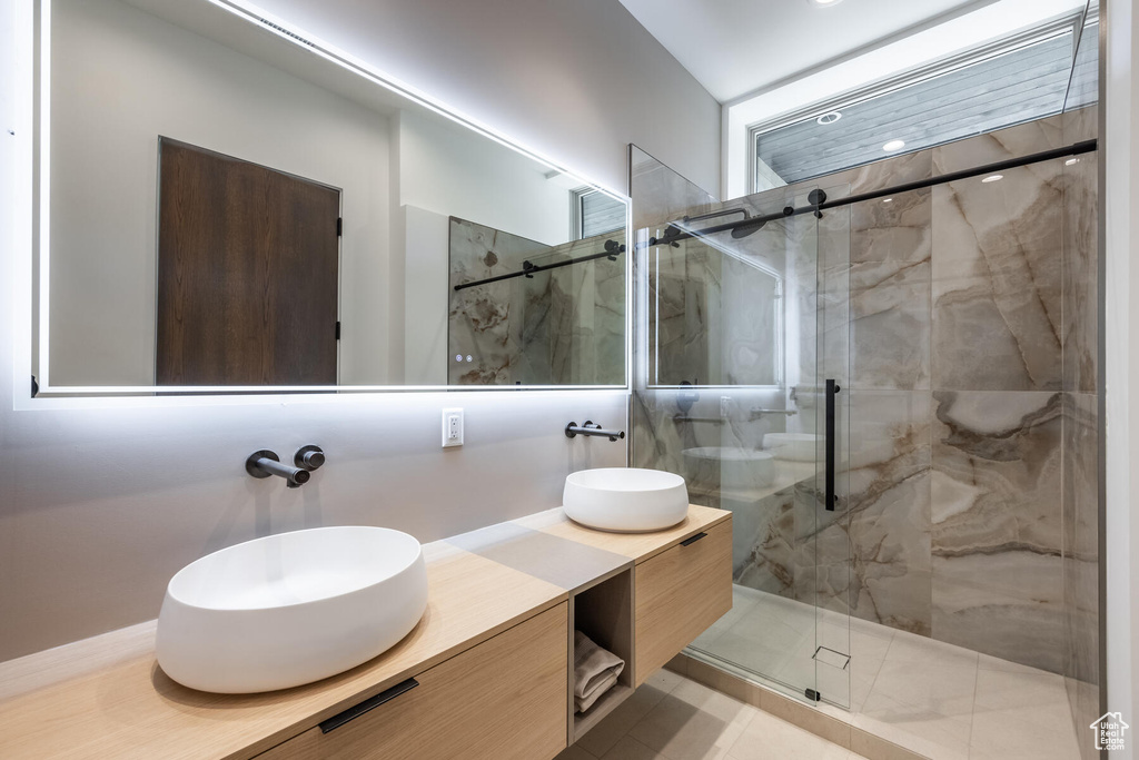 Bathroom with a shower with shower door and vanity