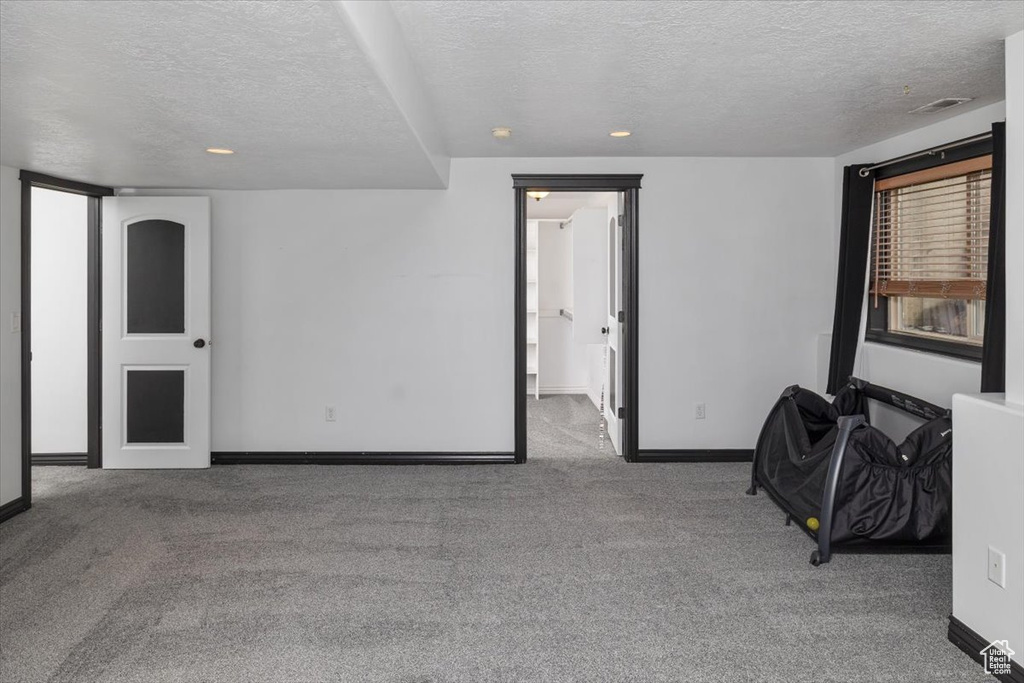 Spare room featuring carpet floors and a textured ceiling