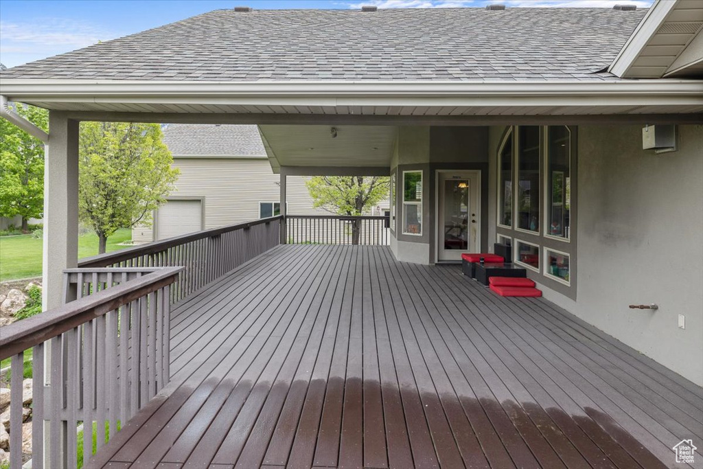 Wooden deck featuring a garage