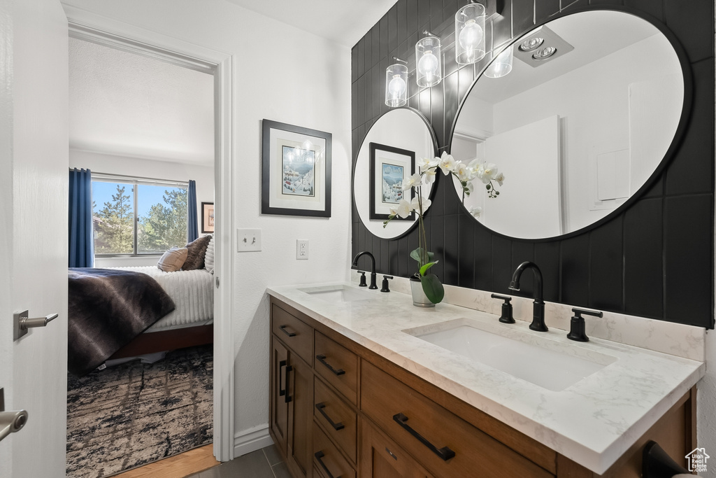 Bathroom with dual vanity and tile flooring