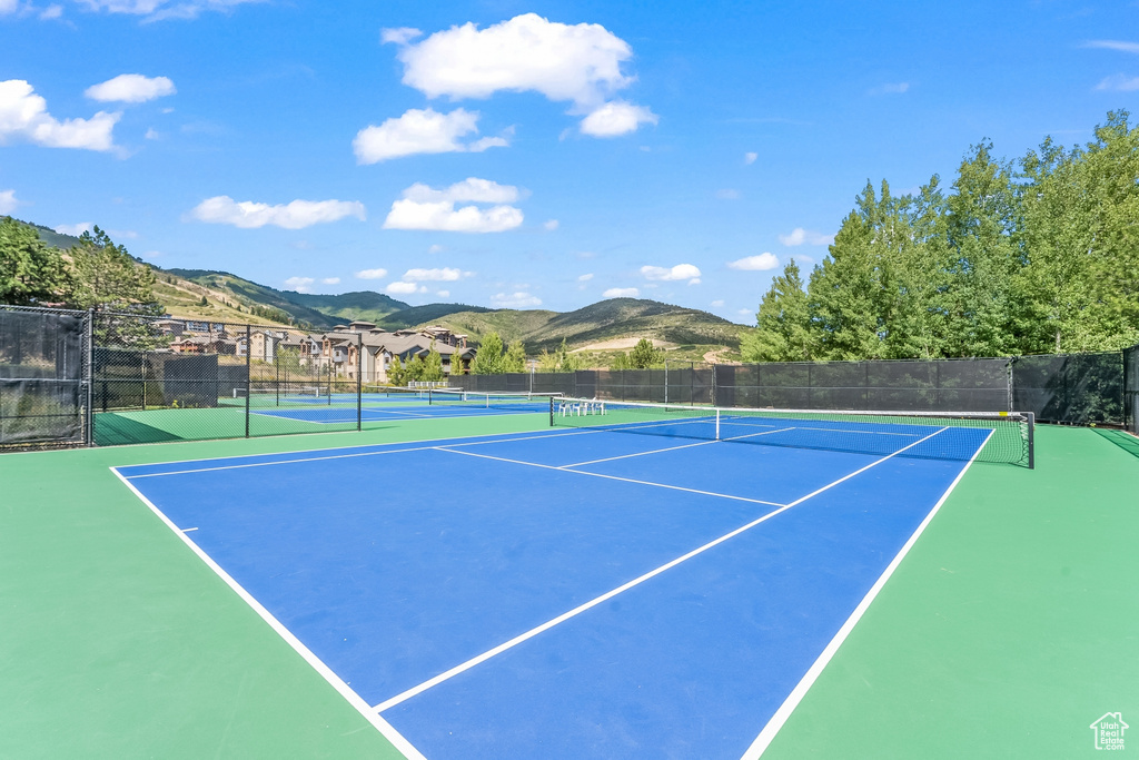 View of tennis court with a mountain view