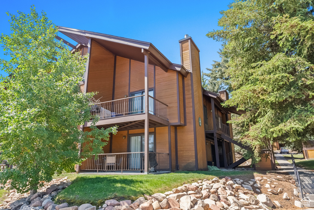 Back of property with a balcony