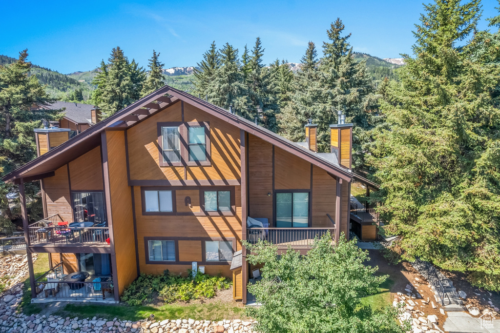 Rear view of property featuring a mountain view