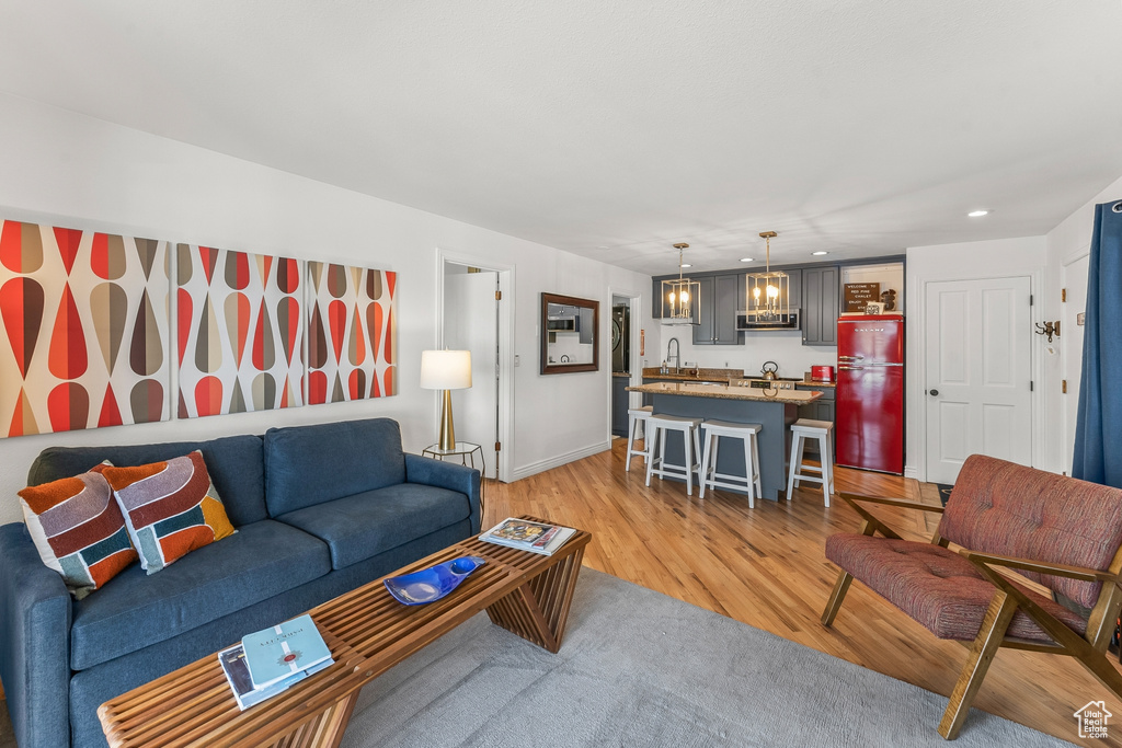 Living room with sink and light wood-type flooring