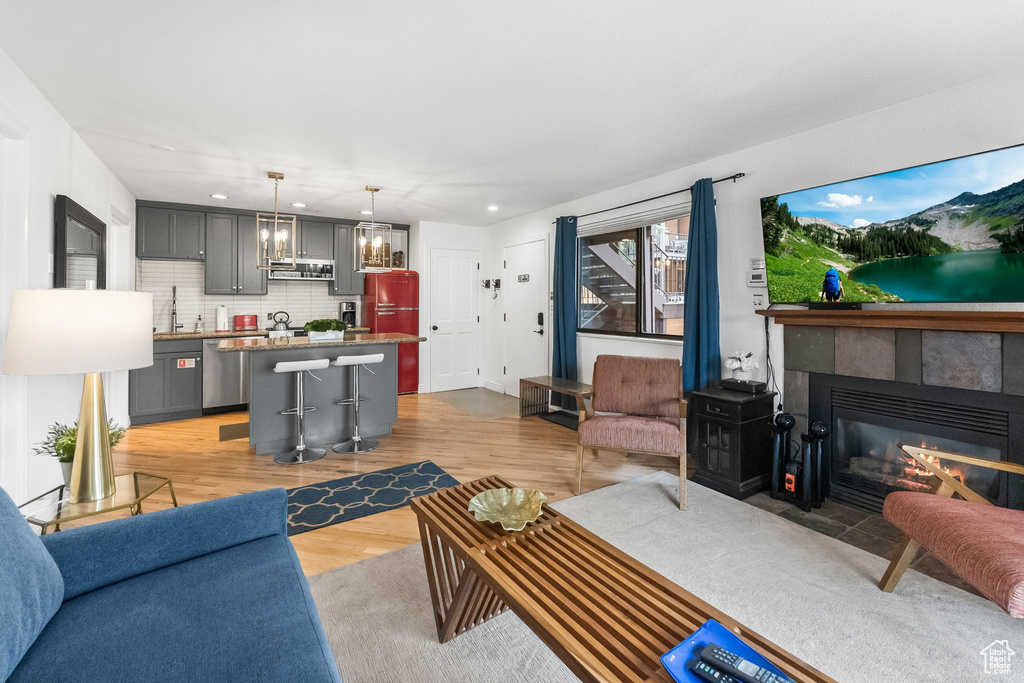 Living room featuring a fireplace, sink, and hardwood / wood-style floors