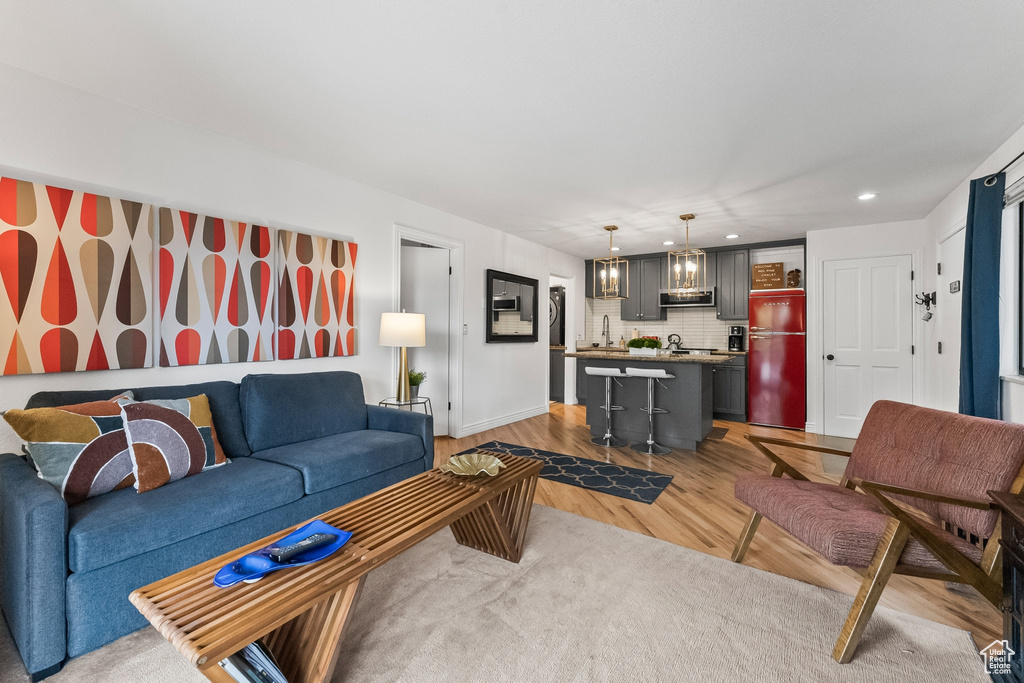 Living room with sink and hardwood / wood-style flooring