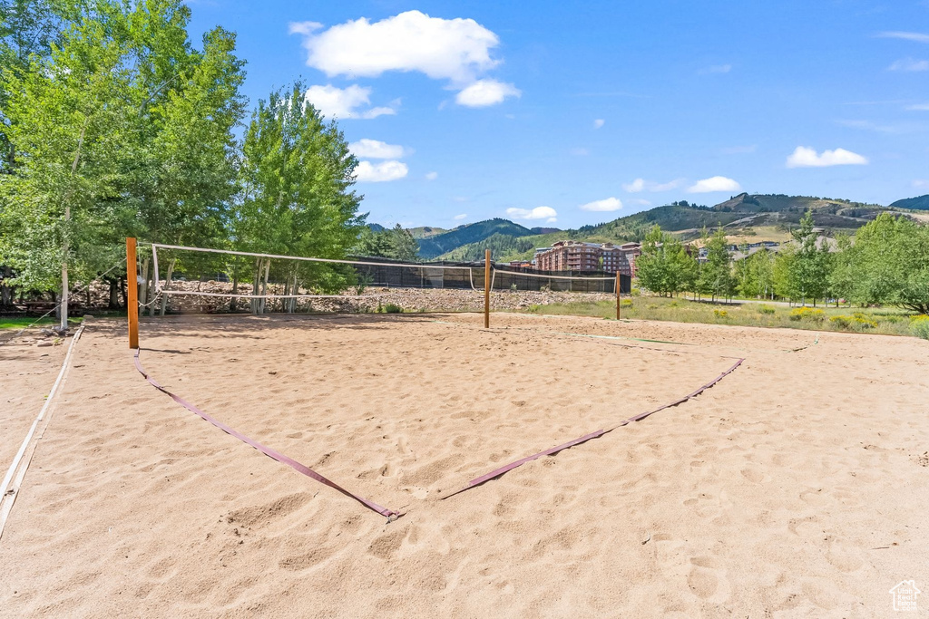 Surrounding community featuring volleyball court and a mountain view