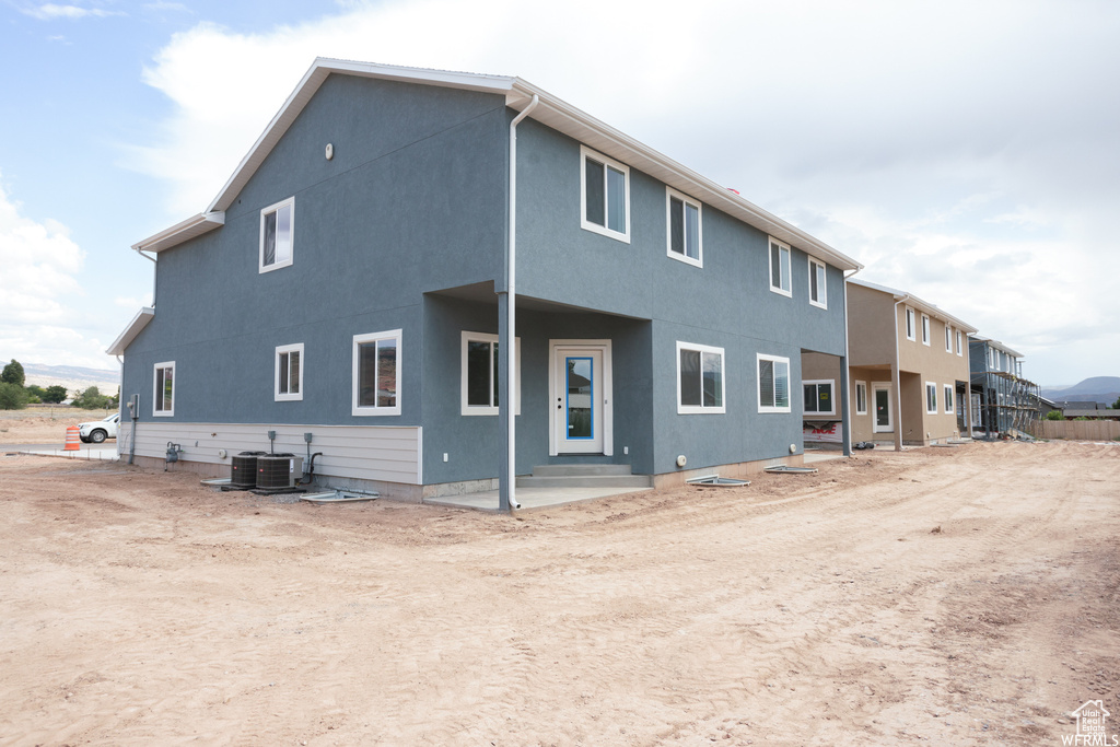 View of front of home featuring central air condition unit