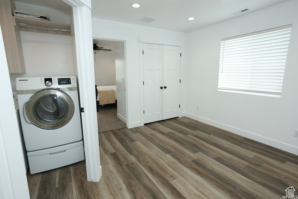 Laundry room with ceiling fan, dark wood-type flooring, and washer / dryer