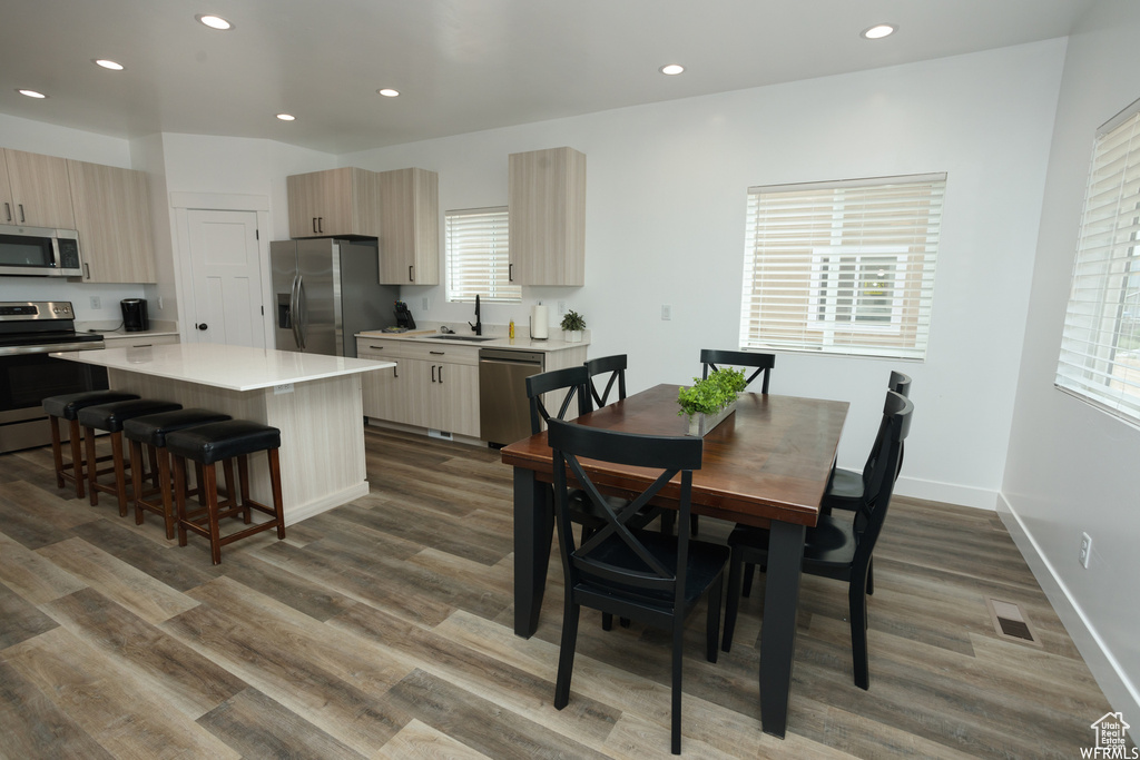 Dining area featuring sink and hardwood / wood-style flooring