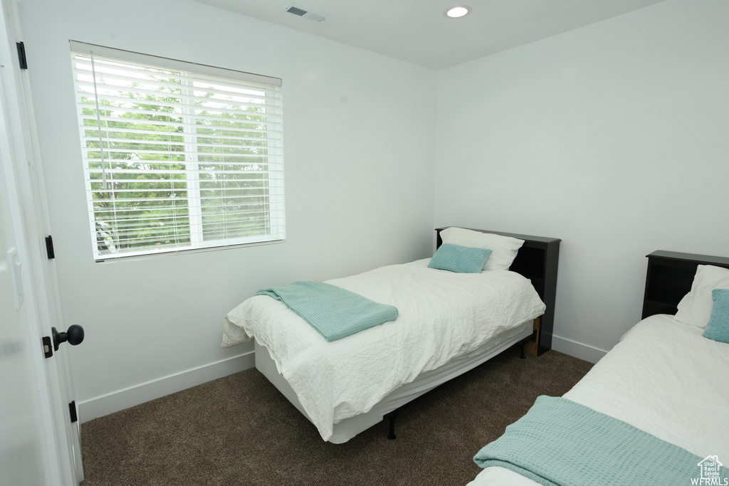 Bedroom with dark colored carpet