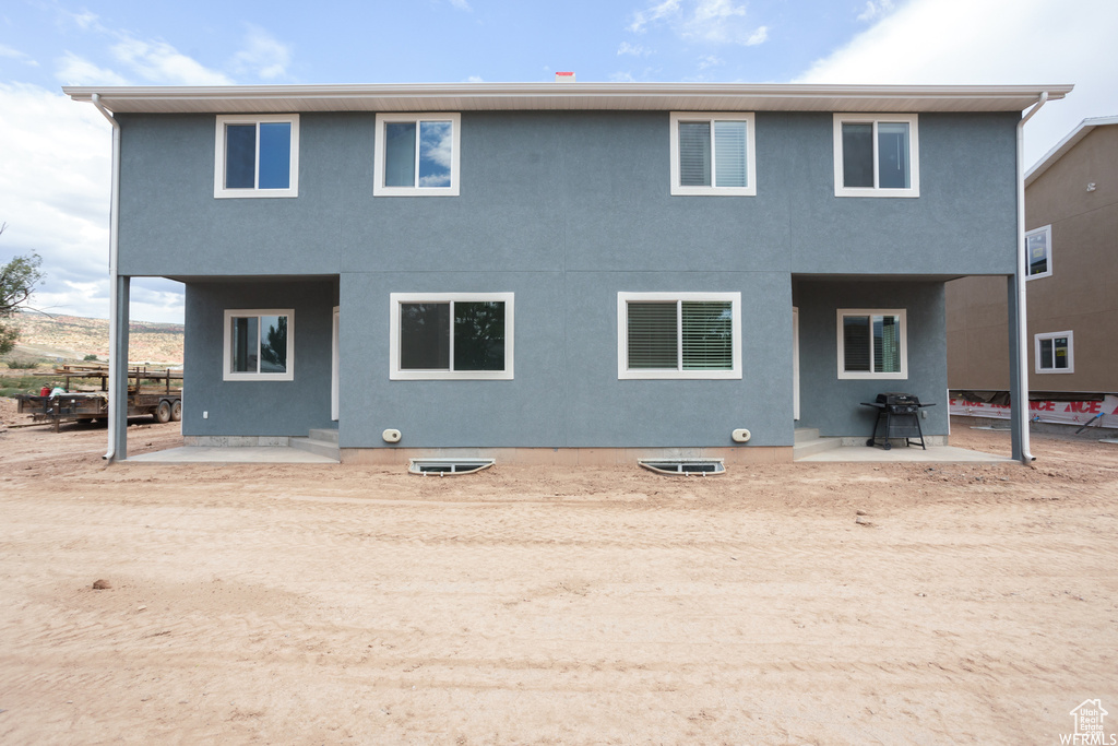 Back of house with a patio