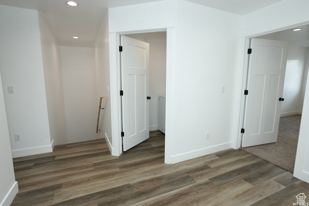 Unfurnished bedroom featuring dark wood-type flooring