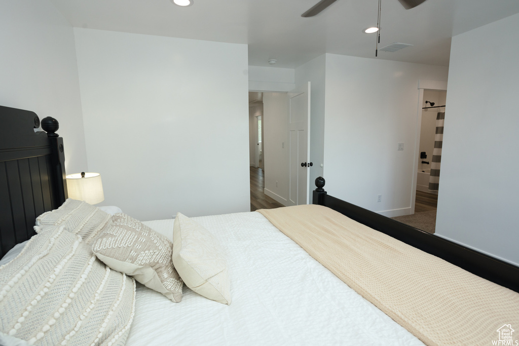 Bedroom with dark hardwood / wood-style flooring and ceiling fan