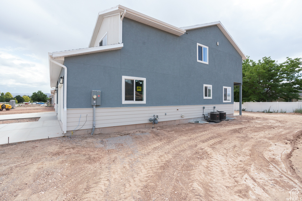 Rear view of property with central AC unit