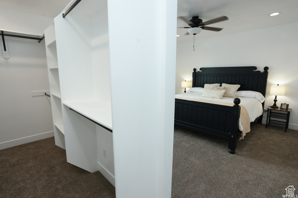 Unfurnished bedroom featuring ceiling fan and dark carpet