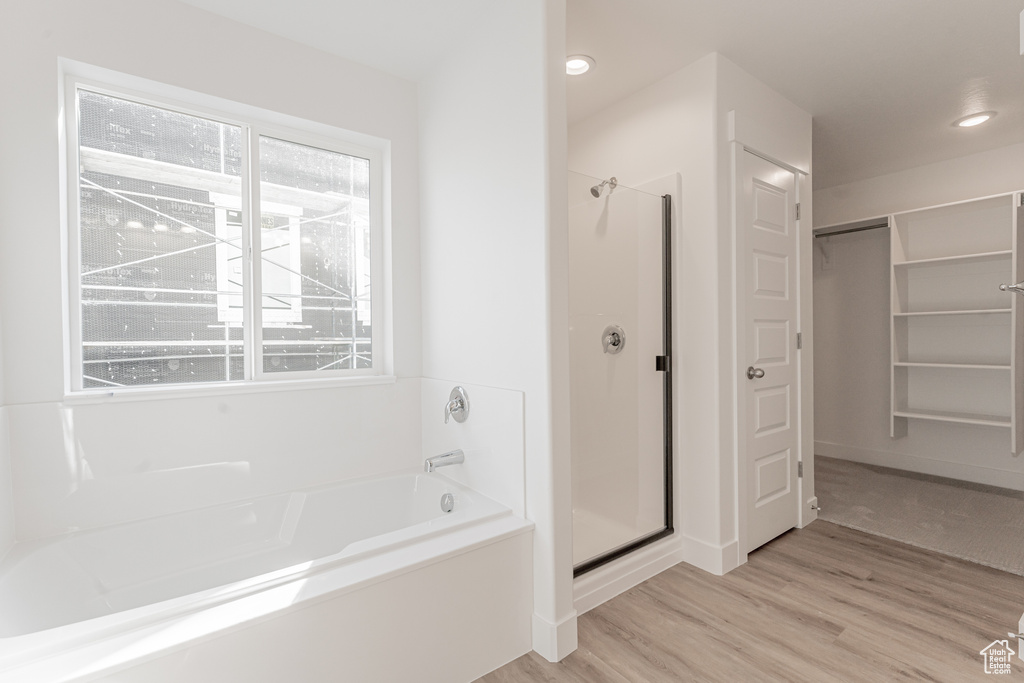 Bathroom with wood-type flooring and plus walk in shower