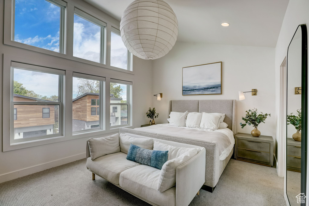 Bedroom featuring carpet and lofted ceiling