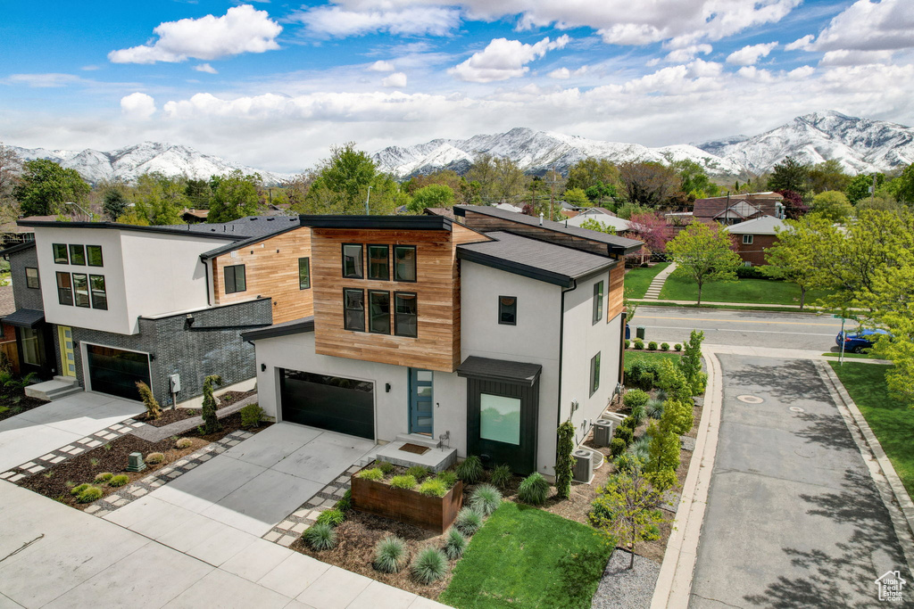 Contemporary house with a mountain view and a garage