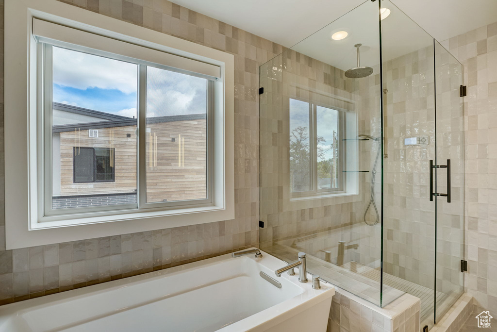 Bathroom with independent shower and bath and tile walls