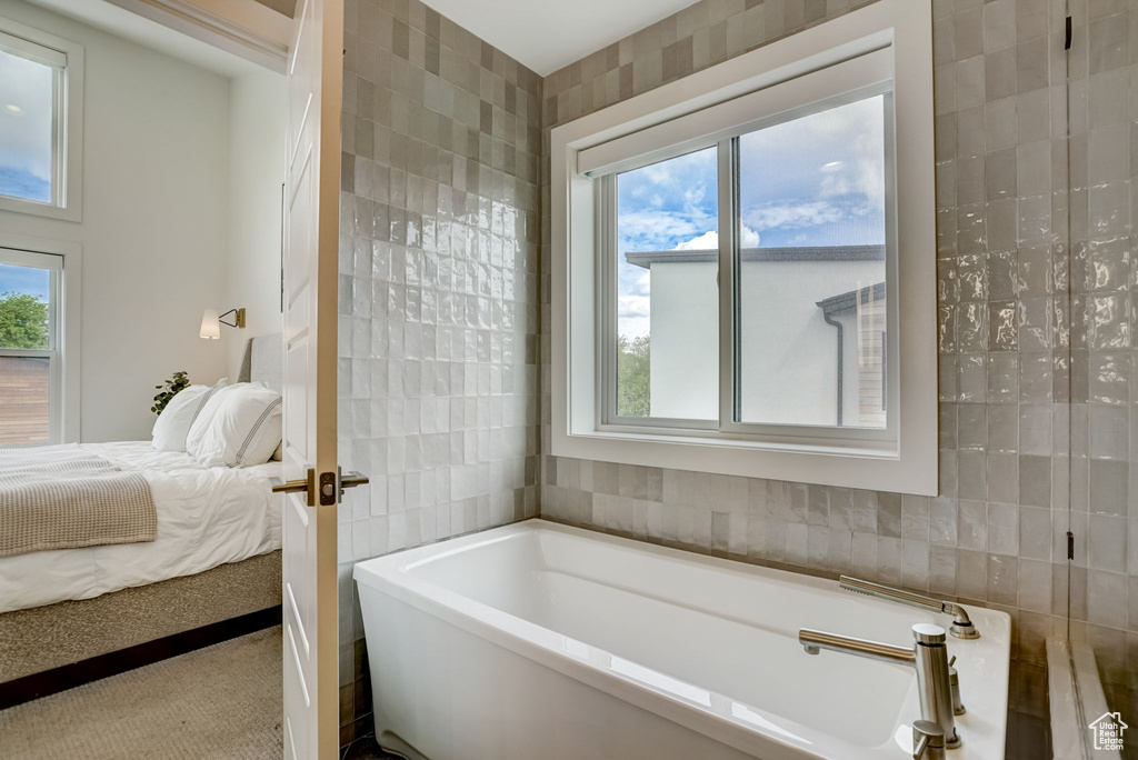 Bathroom with tile walls and a washtub