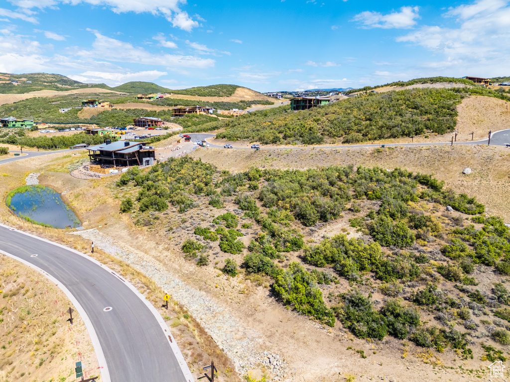 Drone / aerial view with a water and mountain view and a rural view