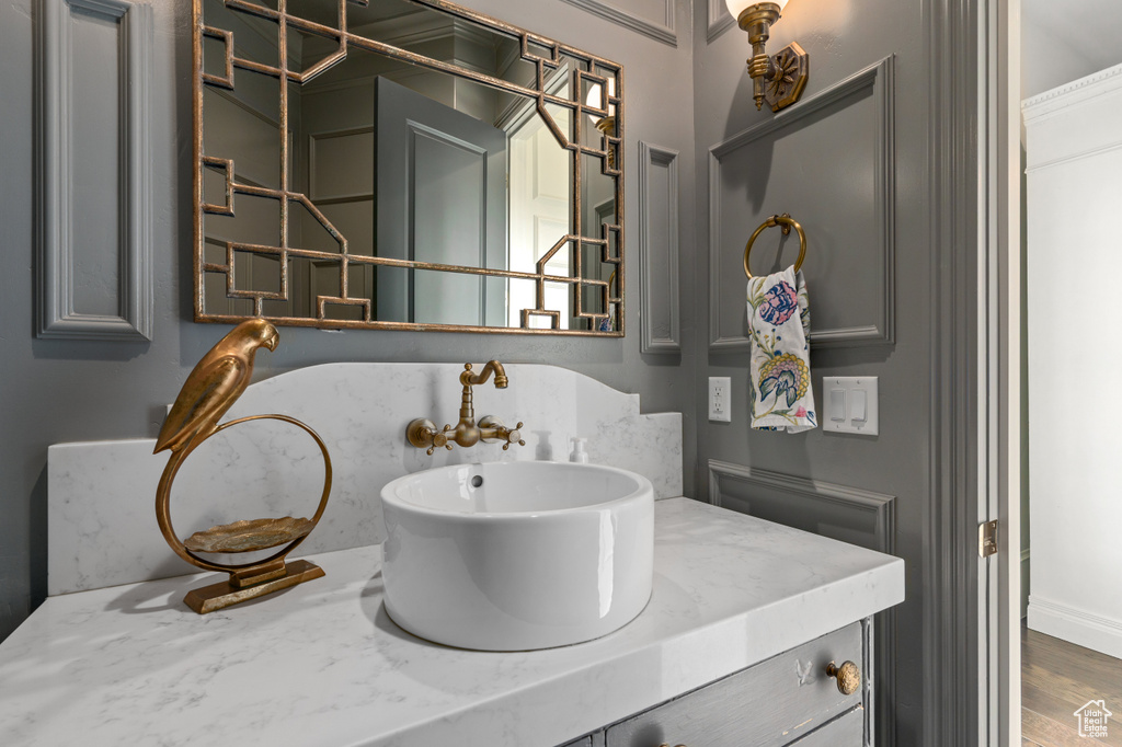 Bathroom featuring hardwood / wood-style floors and large vanity