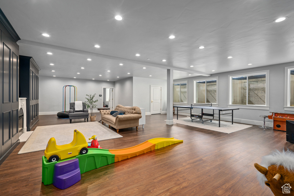 Game room with dark hardwood / wood-style floors