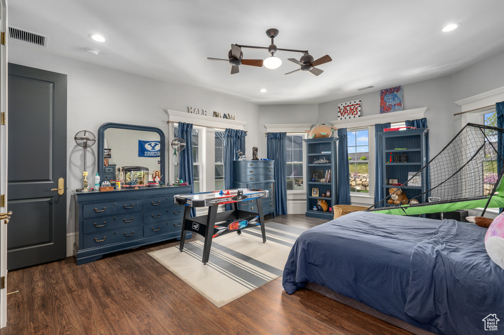 Bedroom with dark hardwood / wood-style flooring and ceiling fan