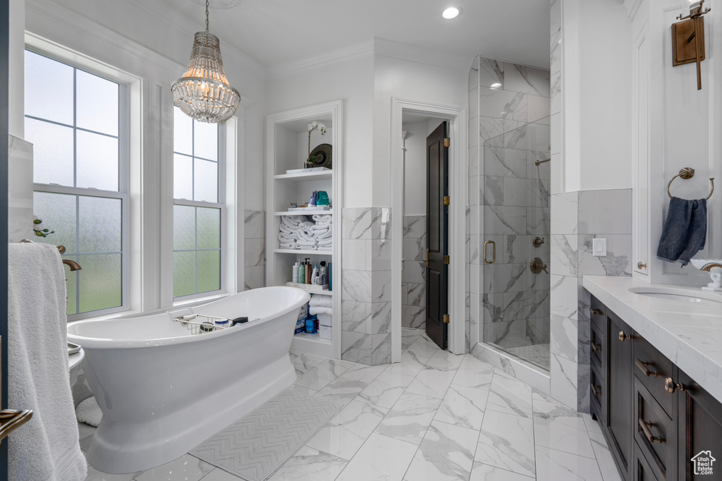 Bathroom with independent shower and bath, crown molding, vanity, tile floors, and a chandelier