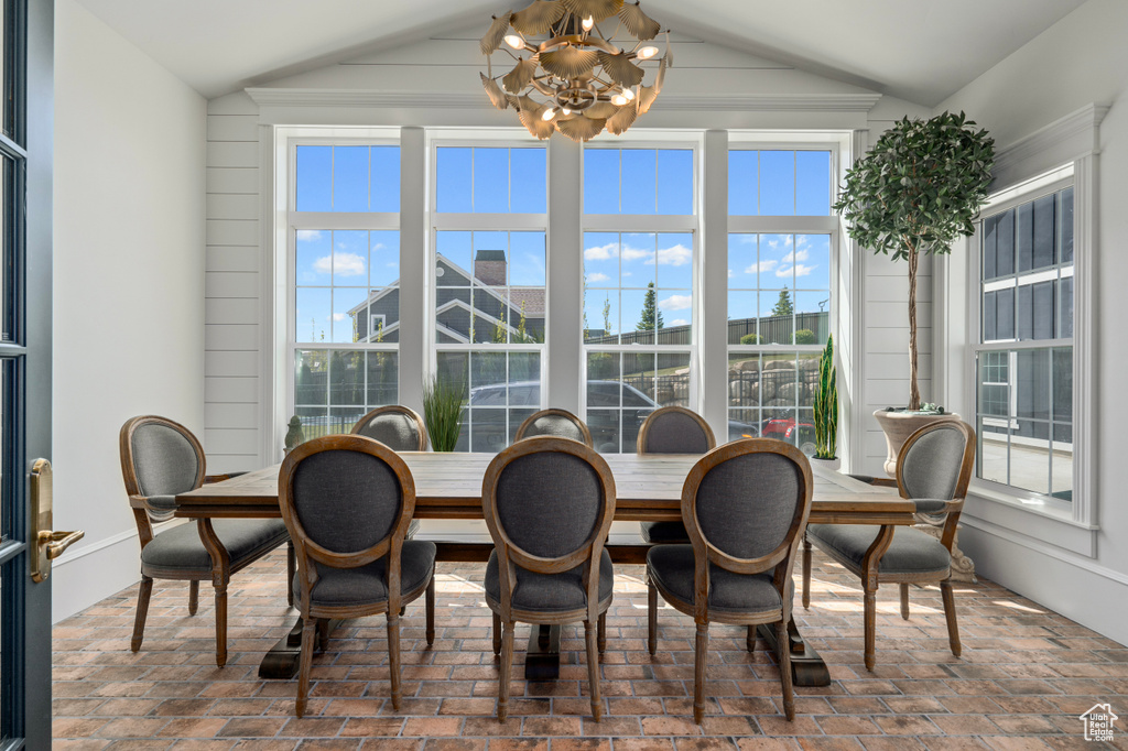 Dining space with an inviting chandelier and lofted ceiling