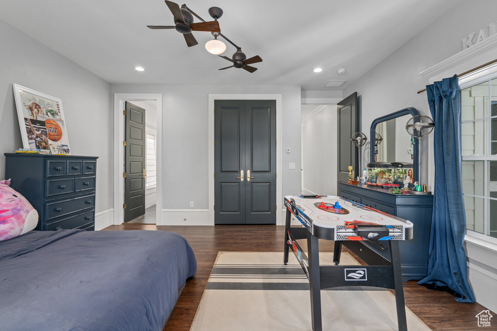 Bedroom featuring ceiling fan and dark hardwood / wood-style floors