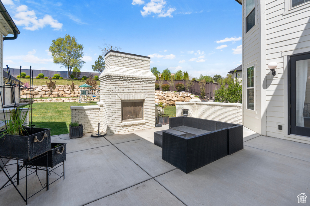 View of patio featuring an outdoor fireplace